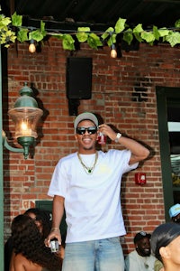 a man in a plaid shirt sitting on a couch